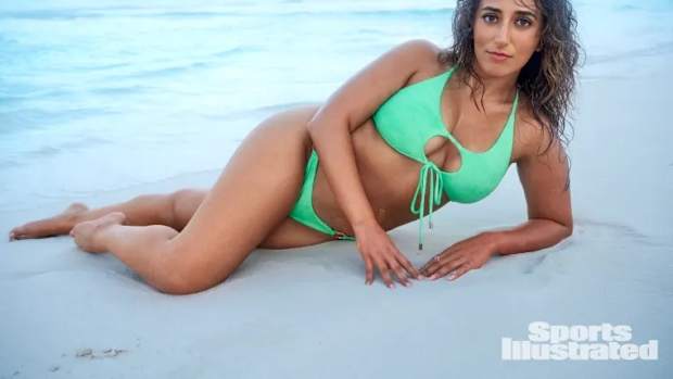 Sarafina El-Badry Nance lays on the sand in a mint green bikini.